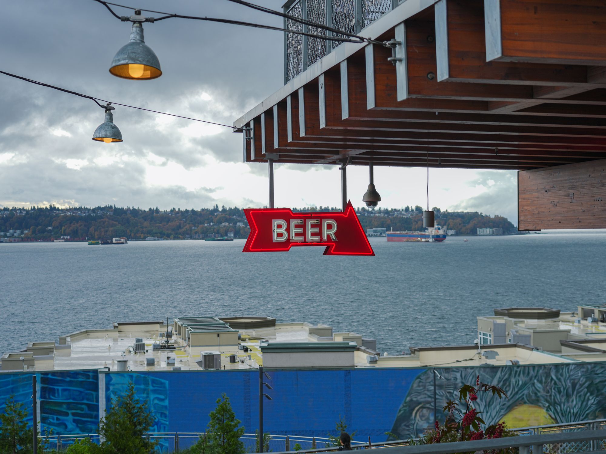 Overlooking Sign Beer Sign Overlooking Waterfront with Industrial View · Free Stock Photo