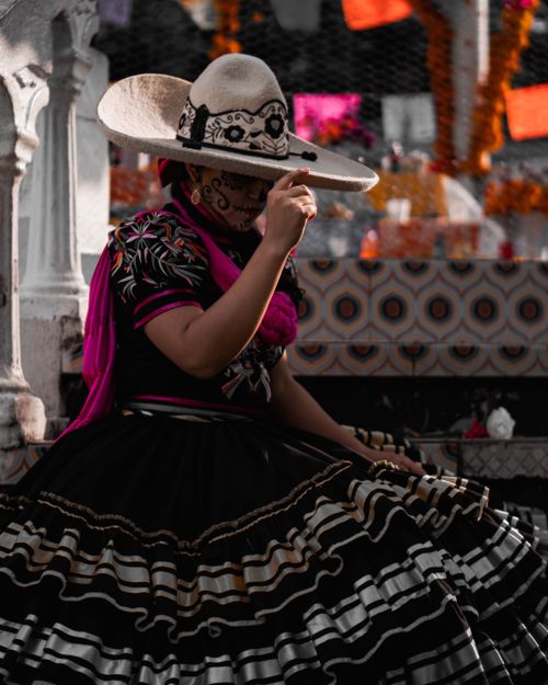 Free Woman in traditional Mexican attire with sombrero celebrates culture. Stock Photo