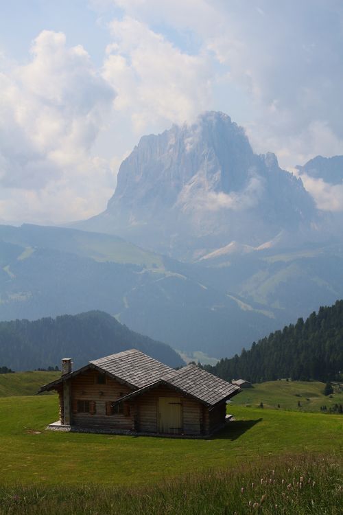 Free Idyllic mountain cabin set against the majestic Dolomites in Trentino-Südtirol, Italy. Stock Photo