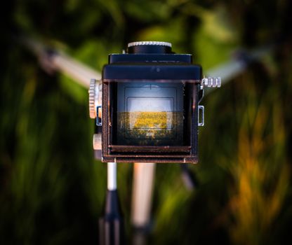 Vintage camera capturing a stunning Alberta landscape through the viewfinder. Perfect for photography enthusiasts.