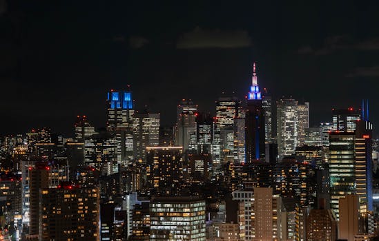 Stunning illuminated Tokyo skyline featuring high-rise buildings and vibrant city lights at night.