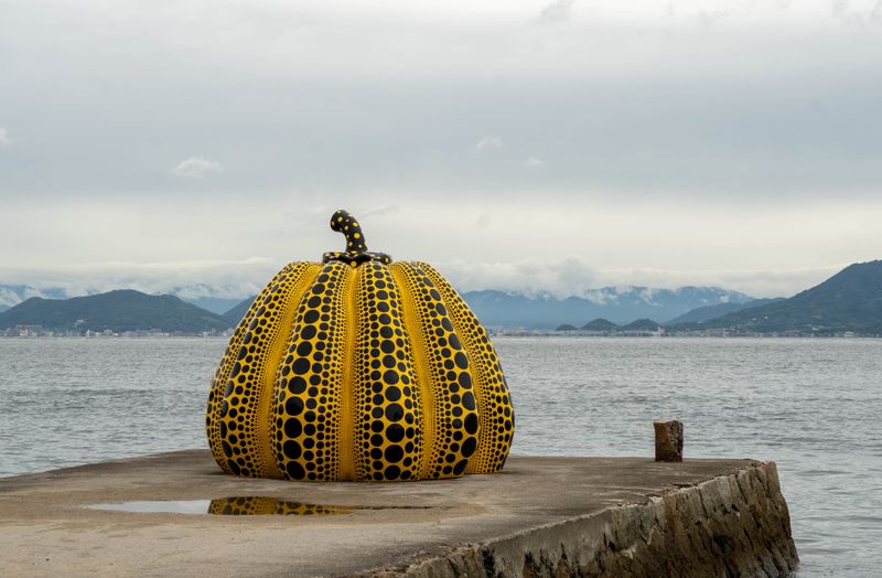 Yayoi Kusama's yellow polka-dot pumpkin sculpture on the Naoshima island pier — Benesse Art Site, Kagawa