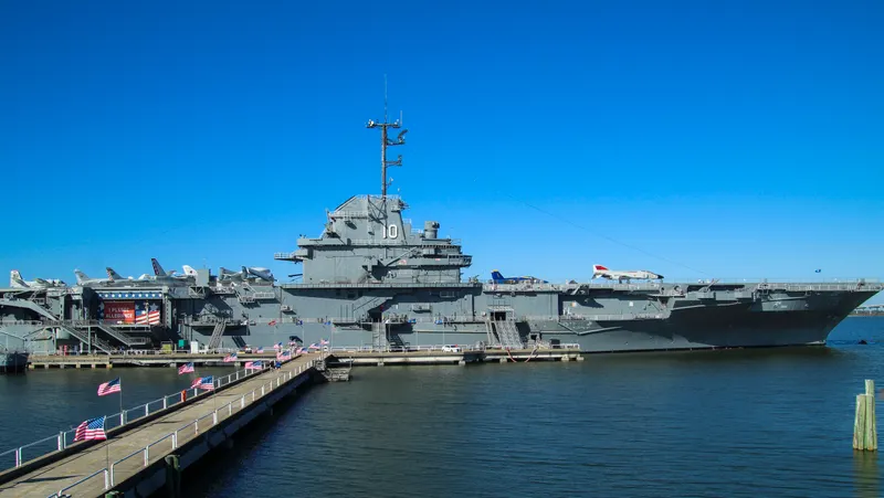 Navy ships at a harbor pier, like the waterfront near Naval Station Norfolk