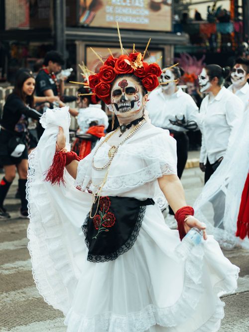 Free Colorful street parade featuring traditional Catrina costumes during Día de Muertos in Mexico City. Stock Photo