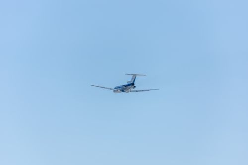 Free A commercial jet flying through a clear blue sky, capturing the beauty of air travel. Stock Photo