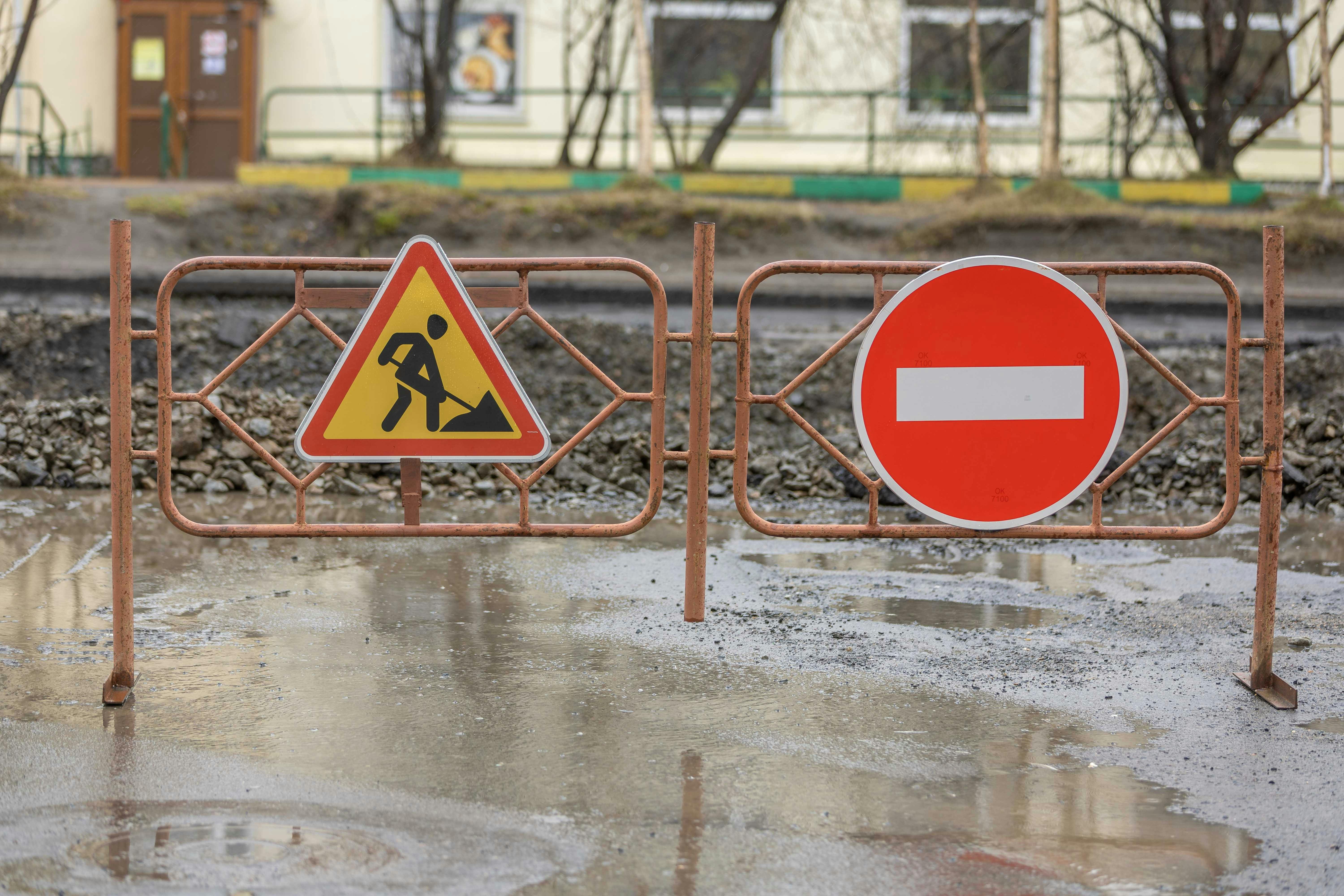 Construction site with warning signs and barriers · Free Stock Photo