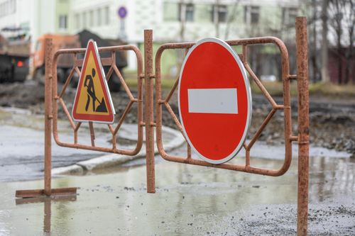 Free Close-up of road work and no entry signs at a construction site on a rainy day. Stock Photo