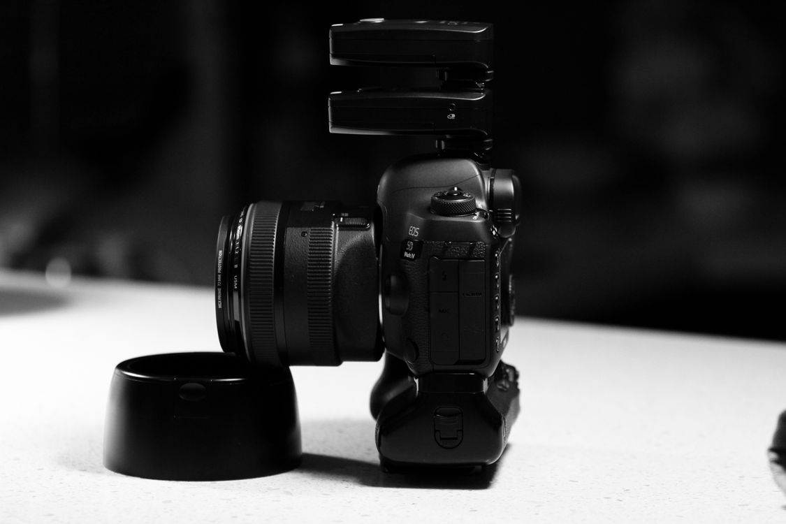Side View of DSLR Camera on White Surface · Free Stock Photo