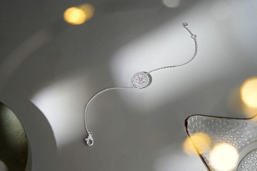 A sparkling diamond bracelet showcased with creative lighting for an artistic effect.