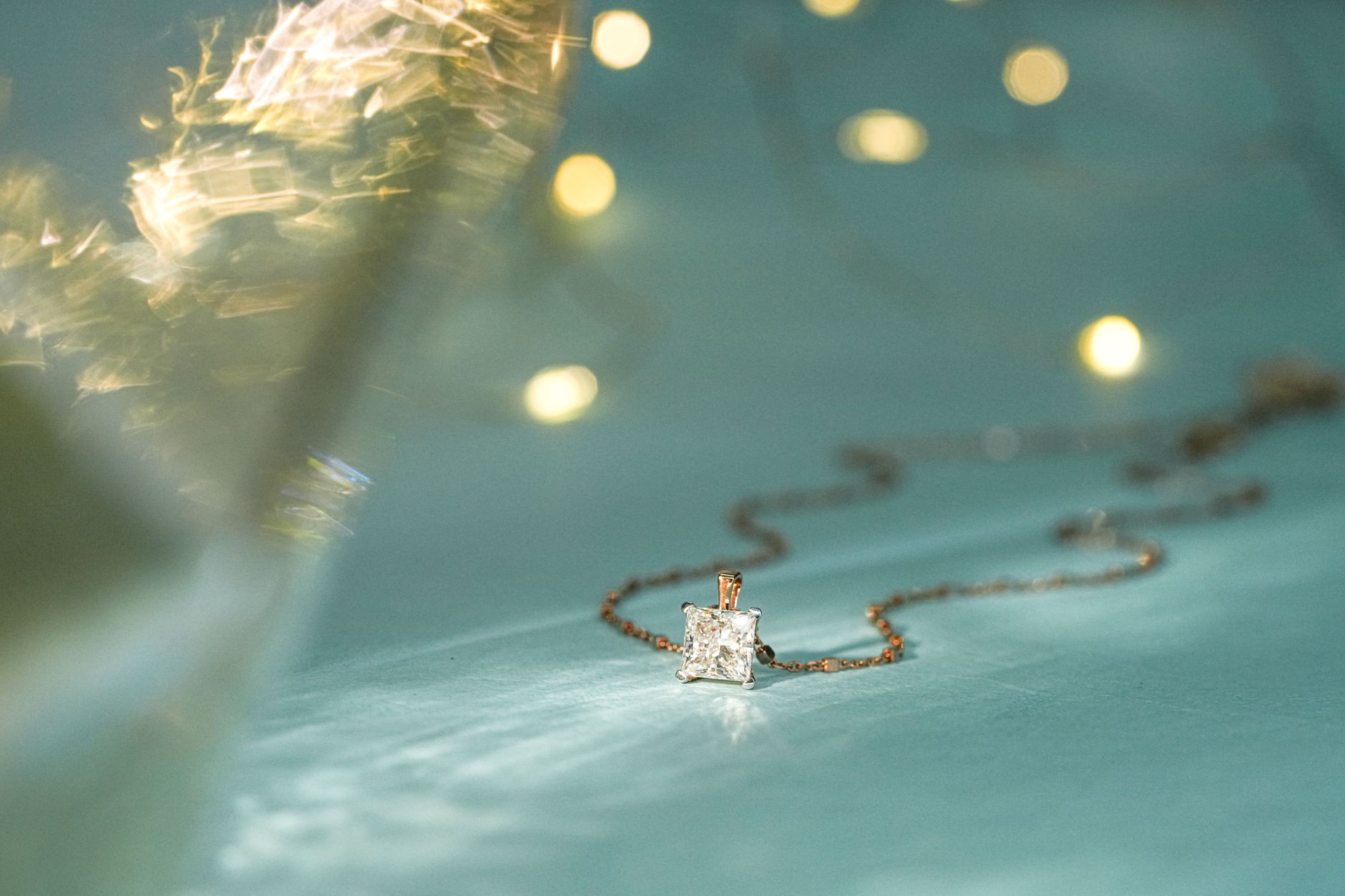 Close-up of a sparkling diamond pendant on a delicate chain, perfect for festive occasions.