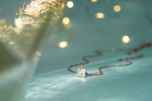 Close-up of a sparkling diamond pendant on a delicate chain, perfect for festive occasions.