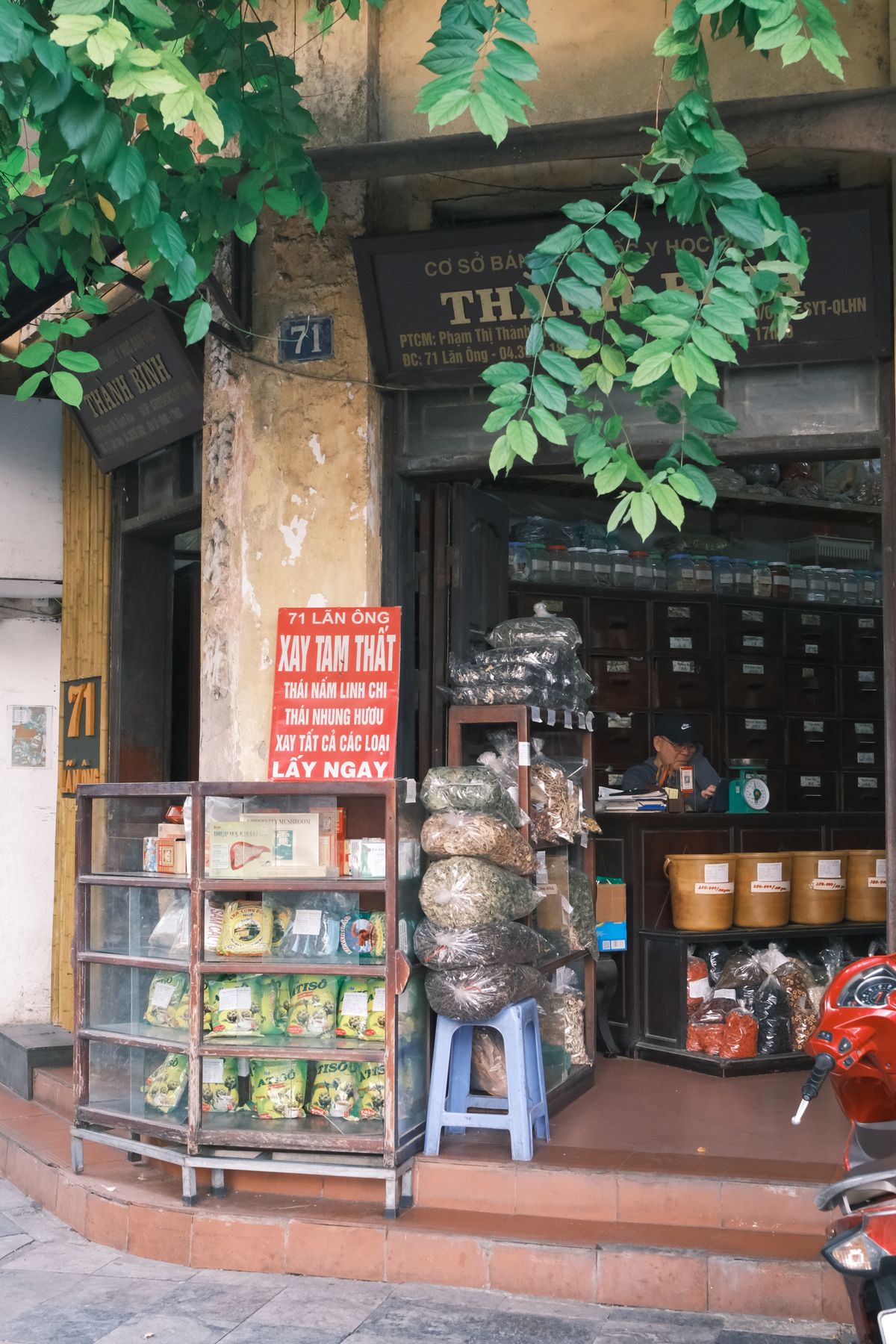 A traditional herbal medicine shop with wooden drawers and dried ingredients