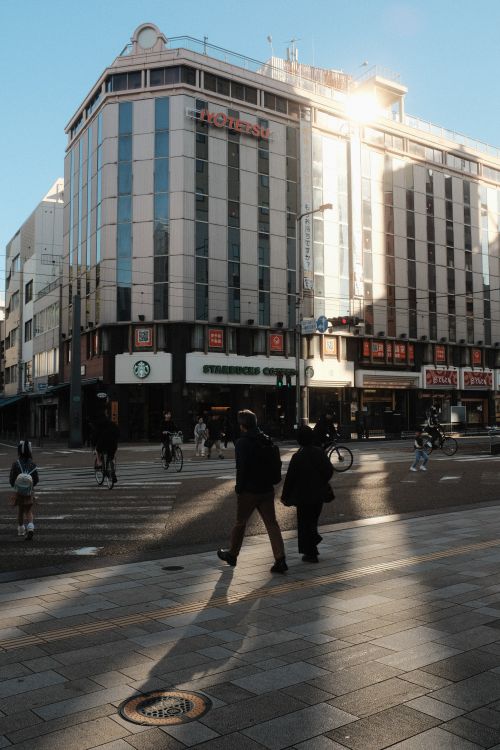 Free Sunny day street view in Matsuyama, showcasing urban architecture and daily life. Stock Photo
