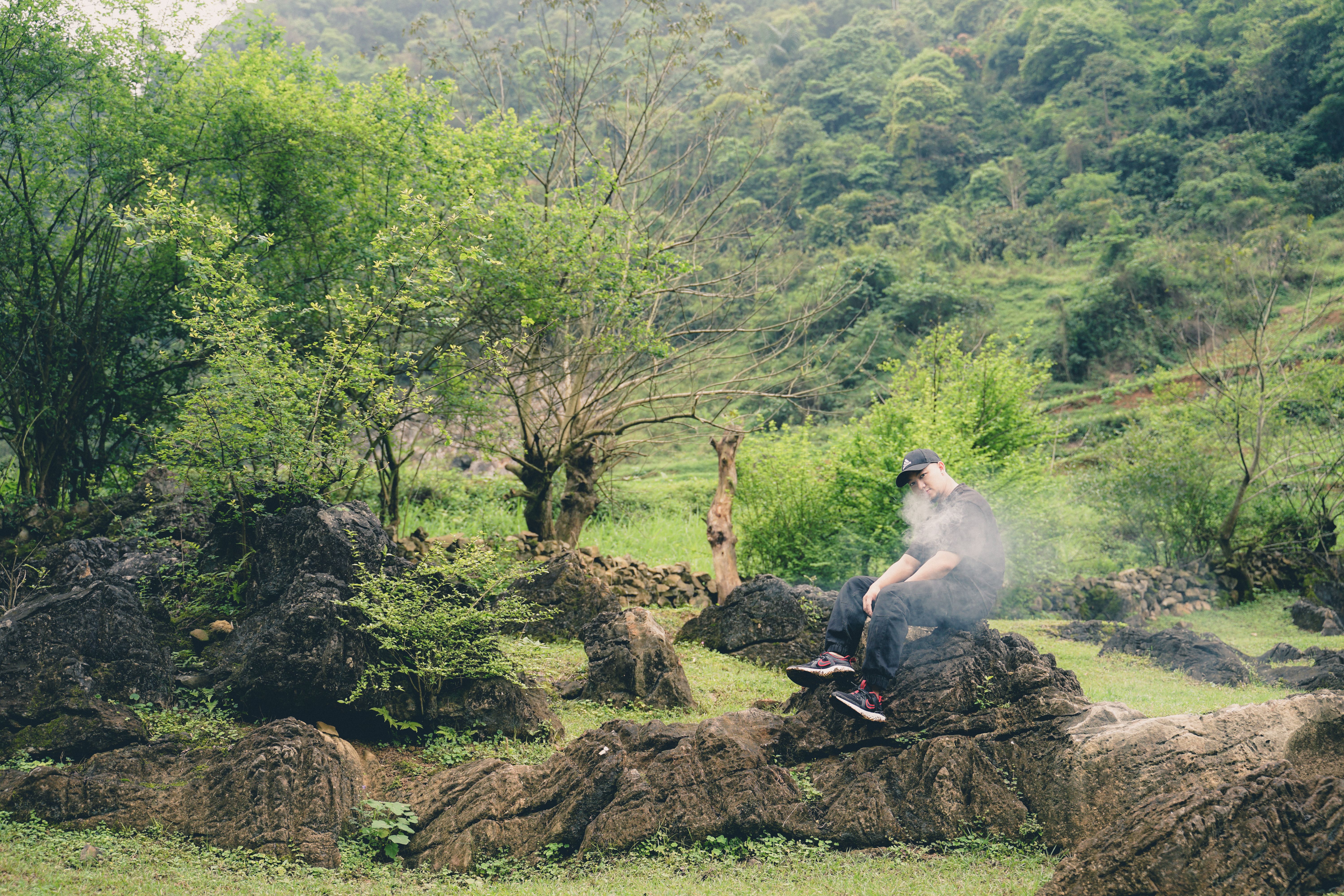 Man Relaxing in Lush Green Forest · Free Stock Photo