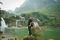 Man Posing by Majestic Ban Gioc Waterfall