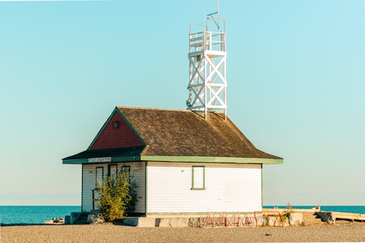 Historic lifeguard station on a Toronto beach under a clear blue sky, offering a serene coastal view.
