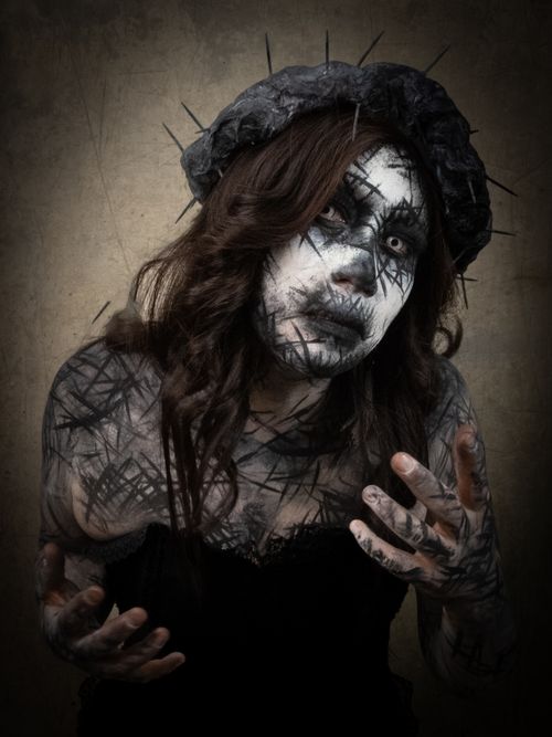Free Gothic-inspired horror costume with dramatic white and black makeup for a haunting effect. Stock Photo