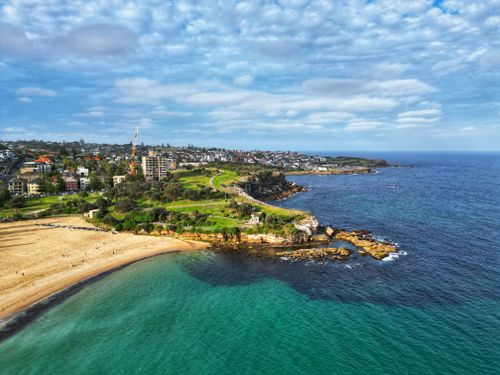 Free Dramatic aerial view of a coastal cityscape in Australia with blue ocean waters and sandy beaches. Stock Photo