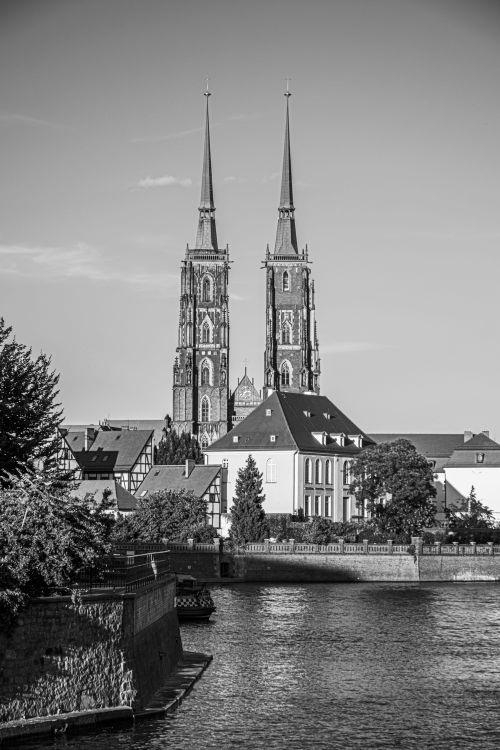 Free Monochrome photograph of Wrocław Cathedral with a riverside view. Stock Photo