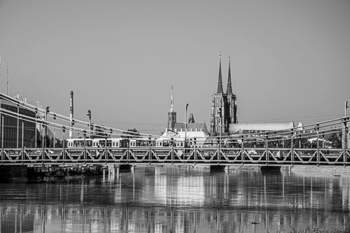 Free Historic Tumski Bridge in Wroclaw with cathedral in background in black and white. Stock Photo