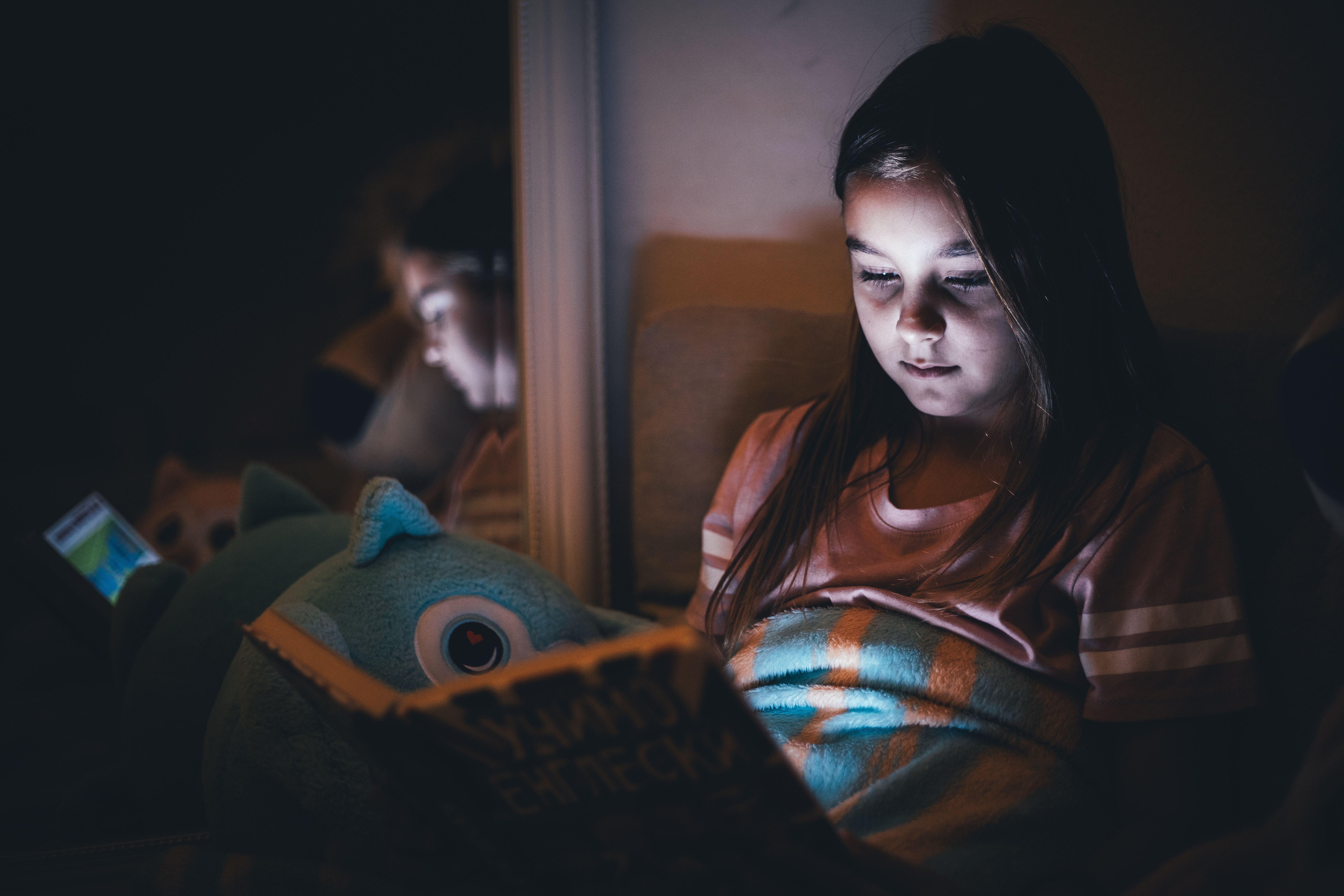 Young Girl Reading by Soft Light at Night · Free Stock Photo