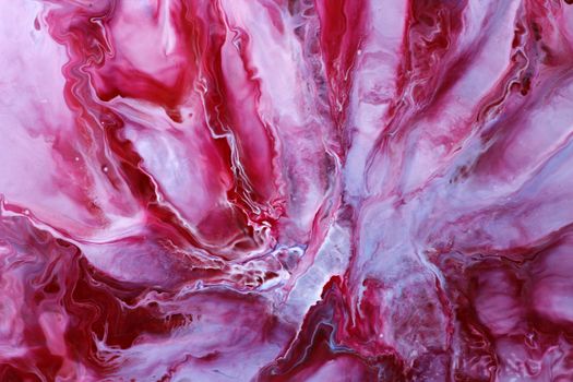 Vibrant pink and red swirled abstract background resembling fluid art.