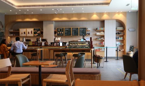 Free Modern coffee shop interior with customers enjoying drinks. Bright and inviting atmosphere. Stock Photo