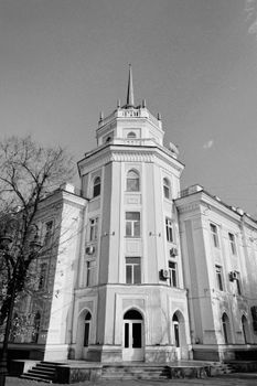 Black and white photo of a historic building in Almaty, showcasing architectural elegance.