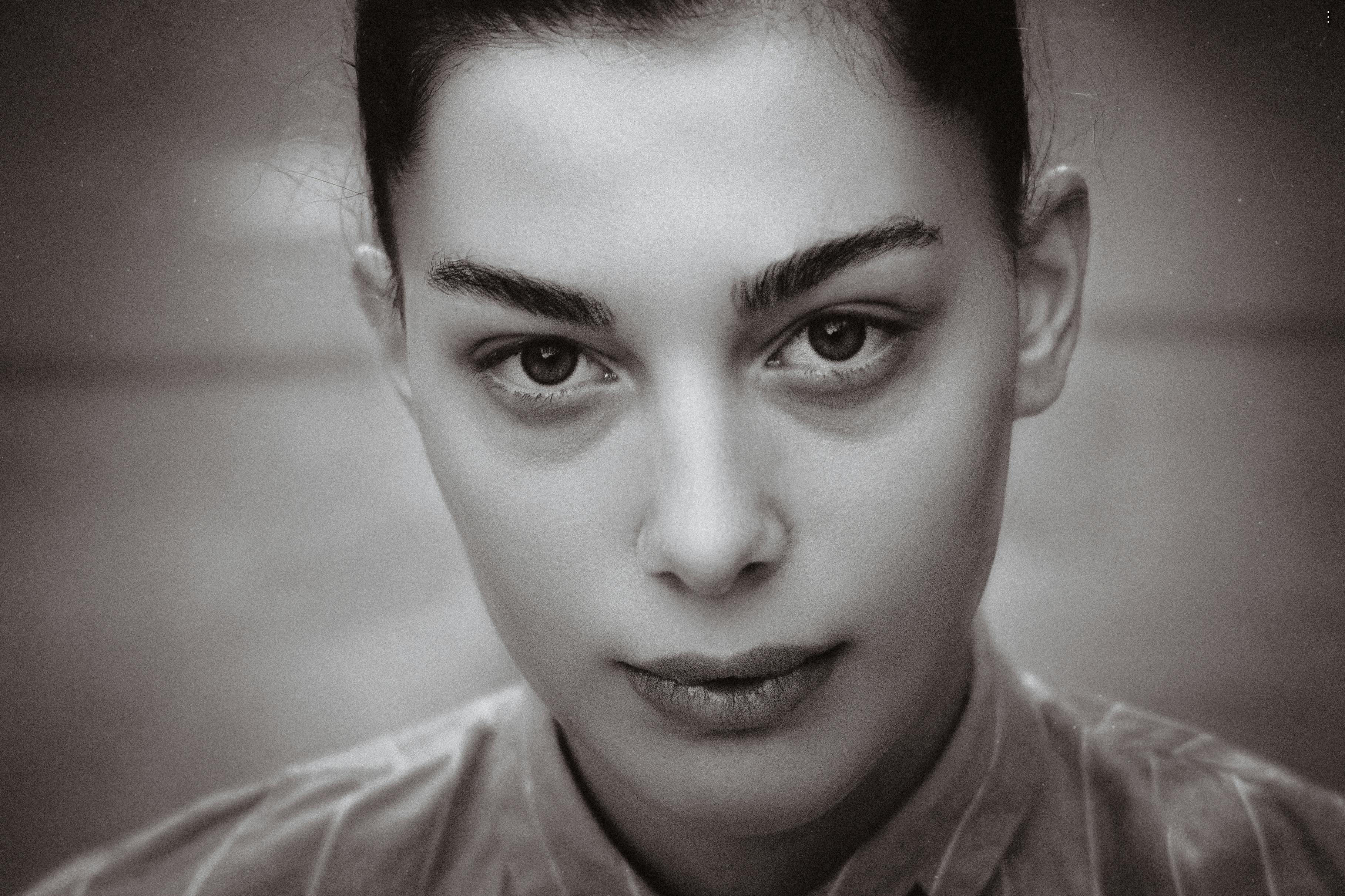 Dramatic black and white portrait photo of a woman with an intense gaze.