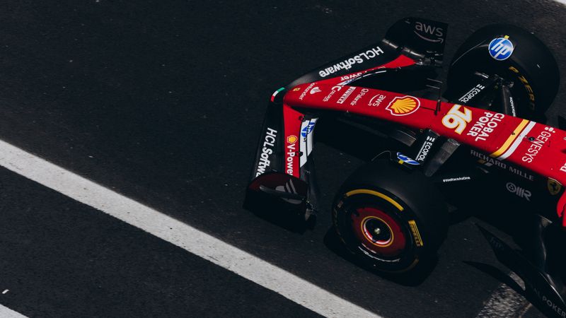 Dynamic overhead shot of a Formula One race car speeding on a track, showcasing high-speed action and racing dynamics.