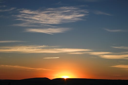 Stunning sunrise landscape with vibrant sky and clouds.