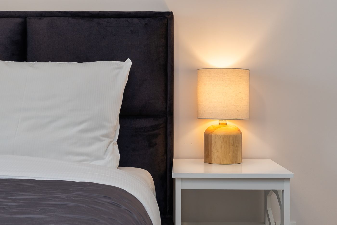 Bedtime routine for better sleep: warm bedside lamp beside a comfortable bed