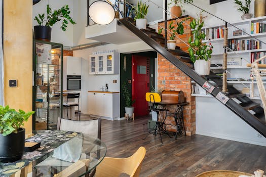 Stylish loft apartment interior featuring a blend of modern design and lush greenery.