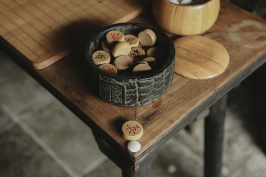 Close-up of a traditional Chinese board game setup with wooden pieces on a table in Huaian, China.
