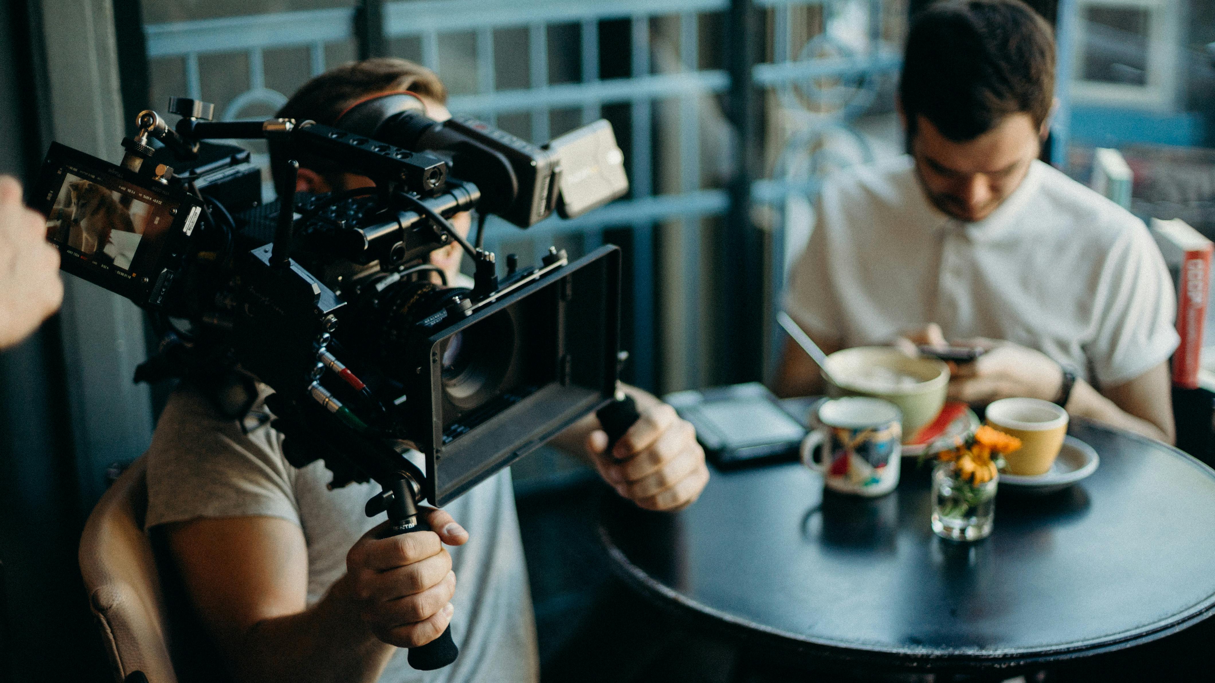 man holding film camera