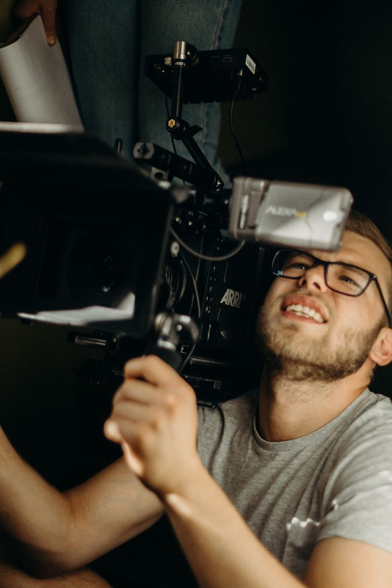 Filmmaker smiling while operating an ARRI camera