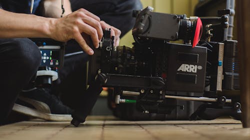 Person Holding Black Professional Camera