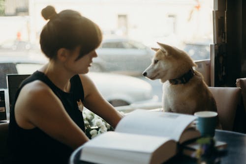 Photo Of Woman Sitting With Dog