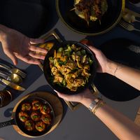 Friends passing bowls across a shared table, photo by Askar Abayev on Pexels