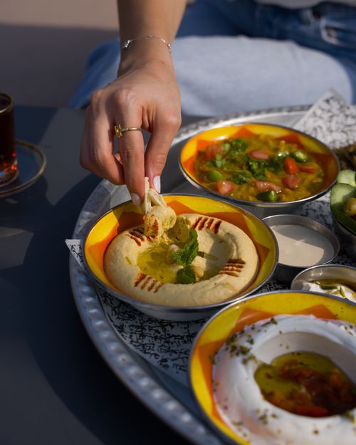 Free A delicious spread of hummus and falafel on a vibrant plate, perfect for a cultural feast. Stock Photo