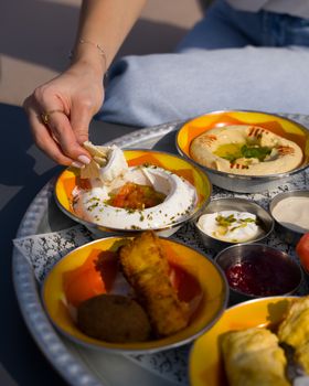A vibrant mezze platter featuring hummus and assorted Middle Eastern dishes.