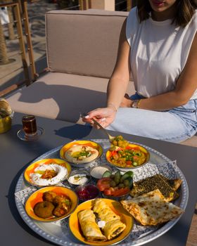 A vibrant Middle Eastern brunch spread with various dishes on an outdoor table, perfect for a cultural dining experience.
