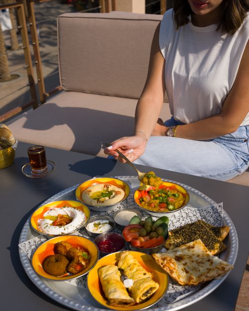 Free A vibrant Middle Eastern brunch spread with various dishes on an outdoor table, perfect for a cultural dining experience. Stock Photo