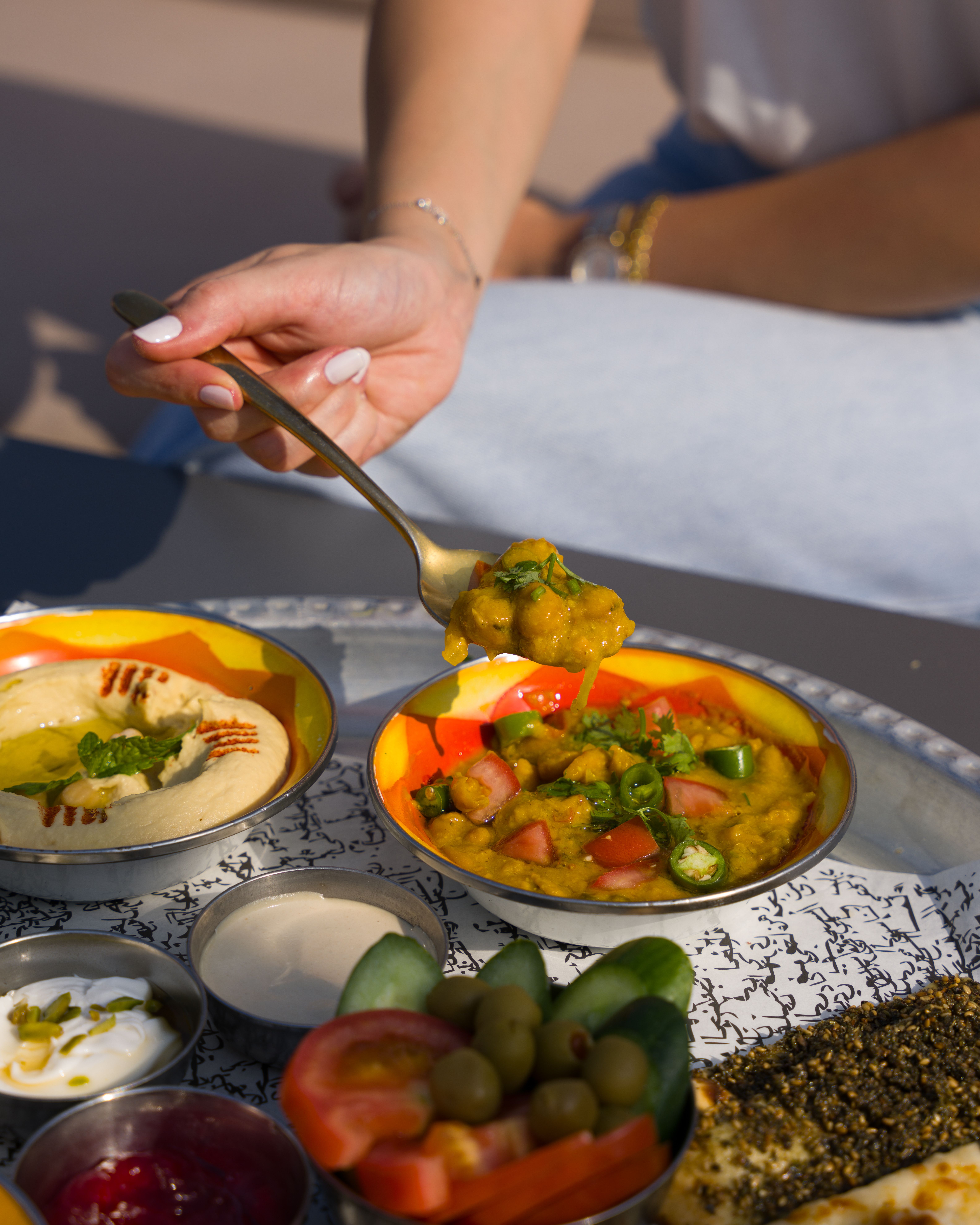 Colorful Mediterranean dishes served outdoors on a tray.