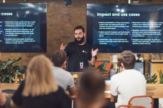 Professional speaker discusses 3D printing applications with attentive audience in tech seminar.