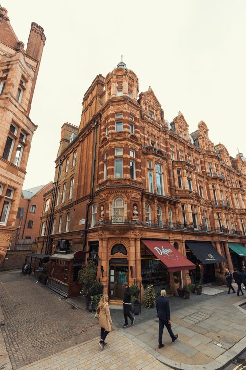 Free Victorian-era building in a busy city street filled with pedestrians. Stock Photo