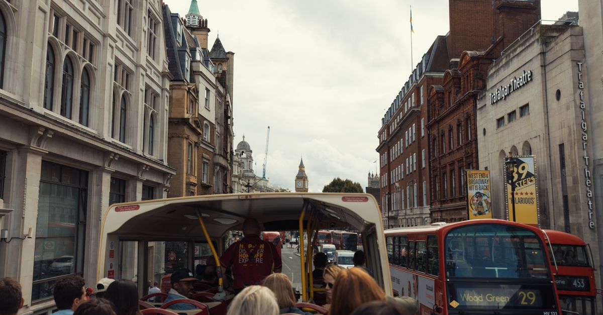 View from a double-decker bus touring central London with Big Ben in the distance.