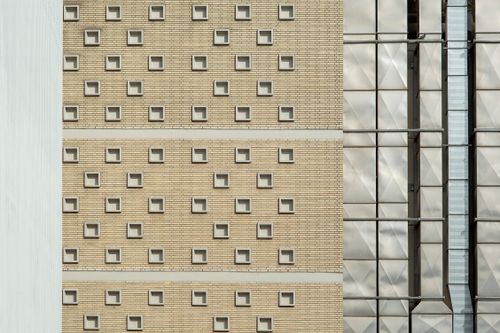 Free Close-up shot of a building facade with repeating square patterns and metallic elements. Stock Photo