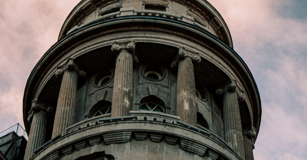 History Building Tower Majestic Historic Building Tower Against Cloudy Sky · Free Stock Photo