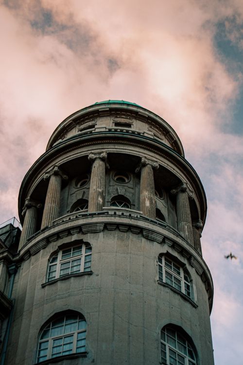 History Building Tower Majestic Historic Building Tower Against Cloudy Sky · Free Stock Photo
